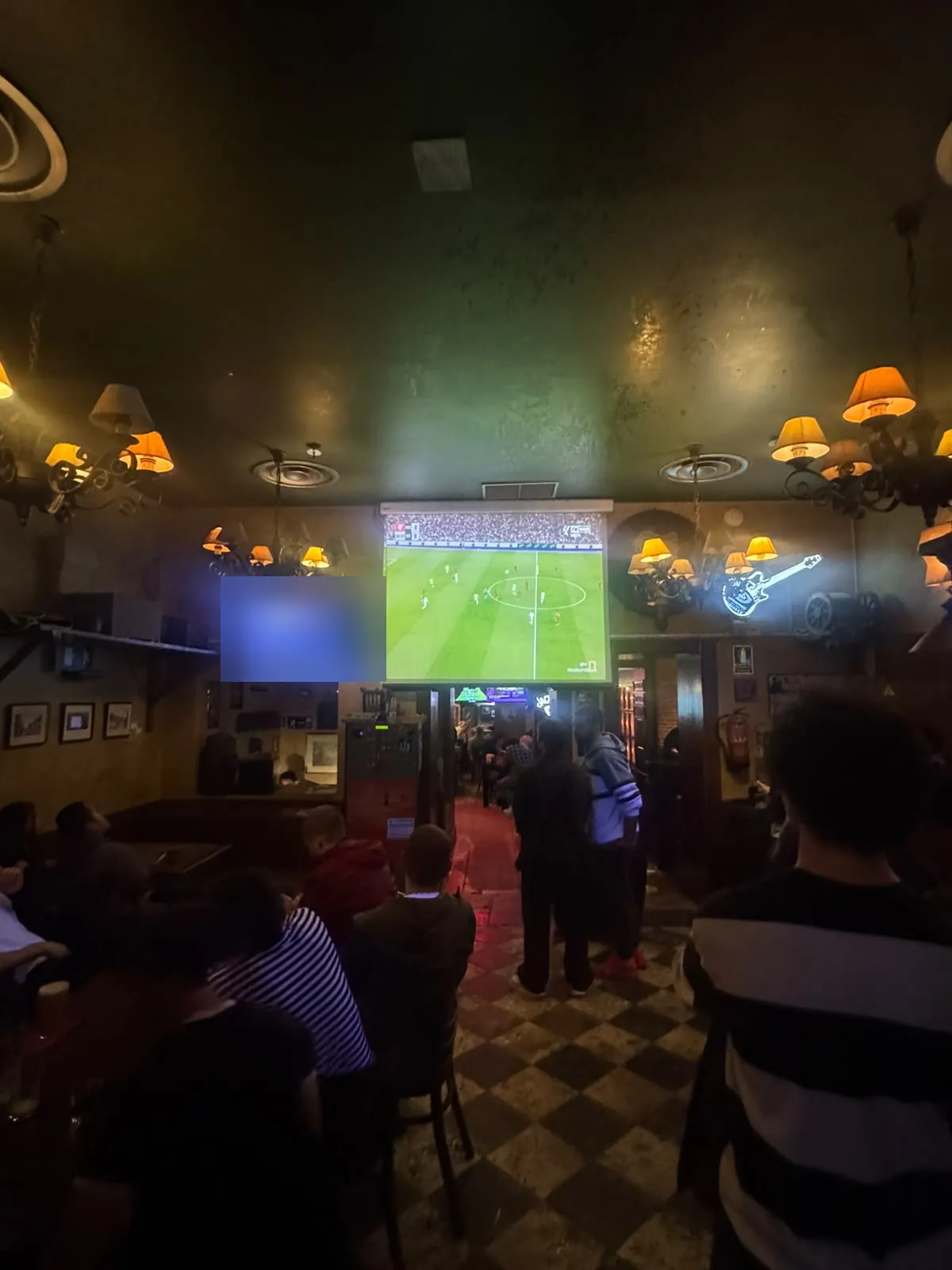 Main room with the big projector screen and TVs at Dubliners, Madrid